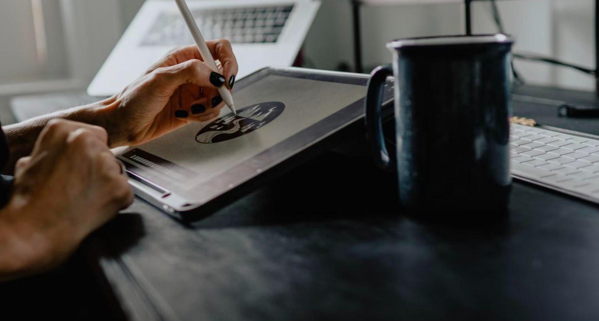 Designer drawing a logo on a tablet with a stylus